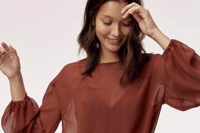 Aritzia income triples